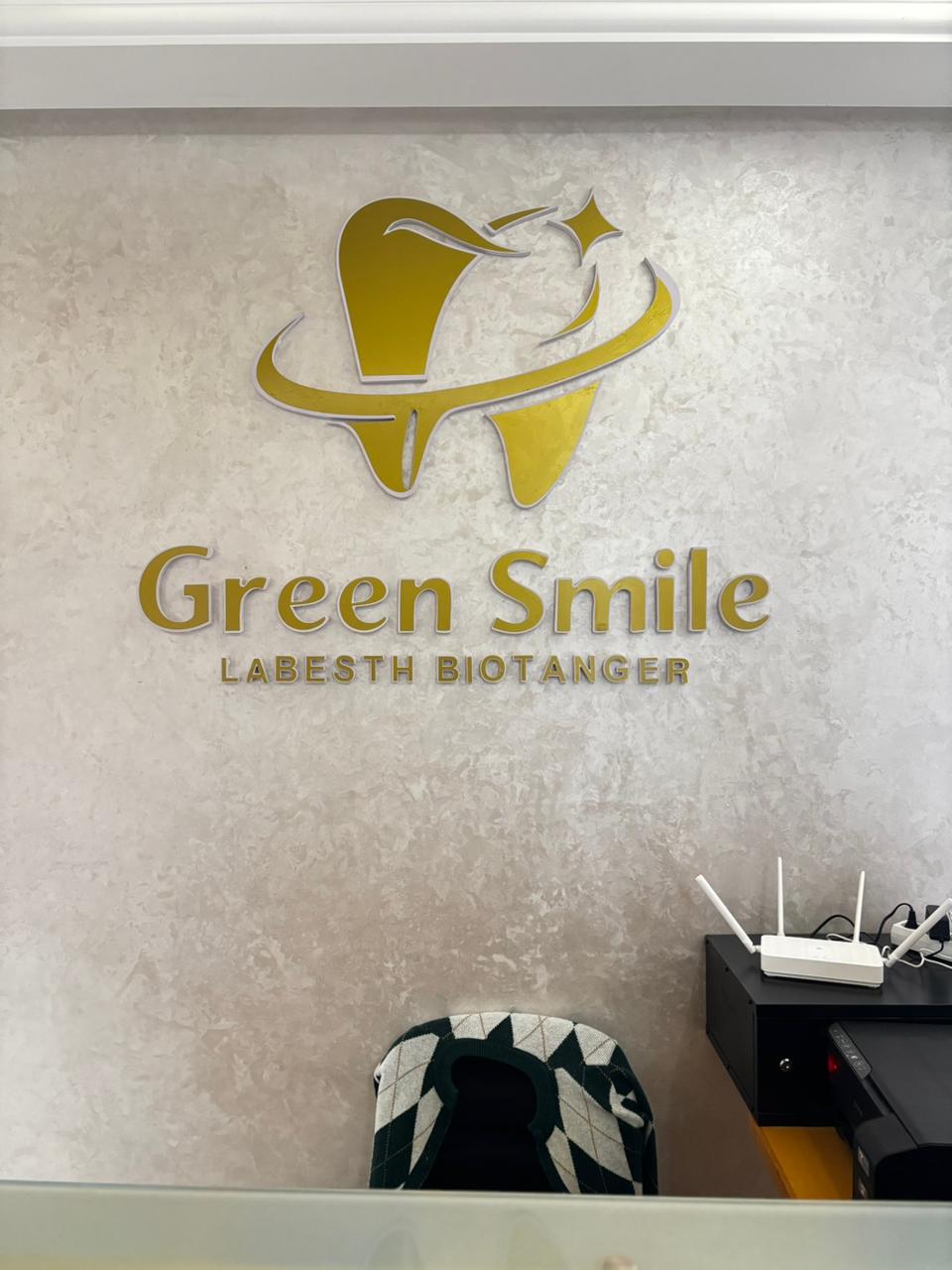 Logo Green Smile en or sur le mur